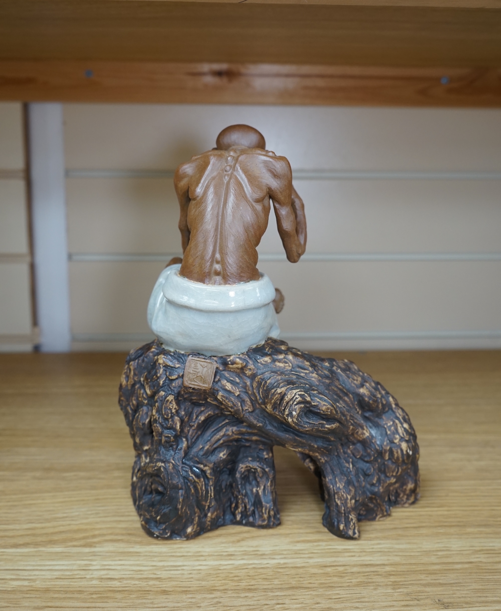 A 20th century Chinese figure of an opium smoker, maker’s seal to reverse and inscribed to interior base, 25cm. Condition - good